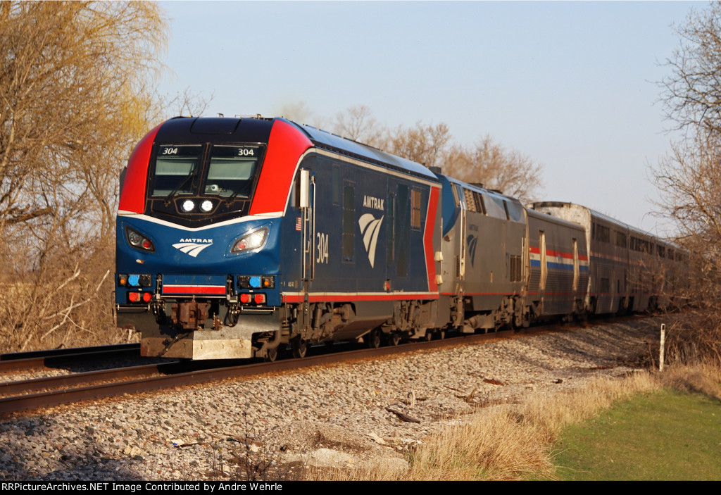 No. 7 glides toward its station stop in the bright light of a beautiful spring afternoon